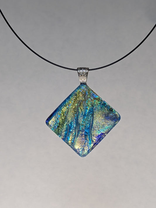 A square blue and gold fused glass pendant with a silver metallic clasp on a black stainless steel necklace.