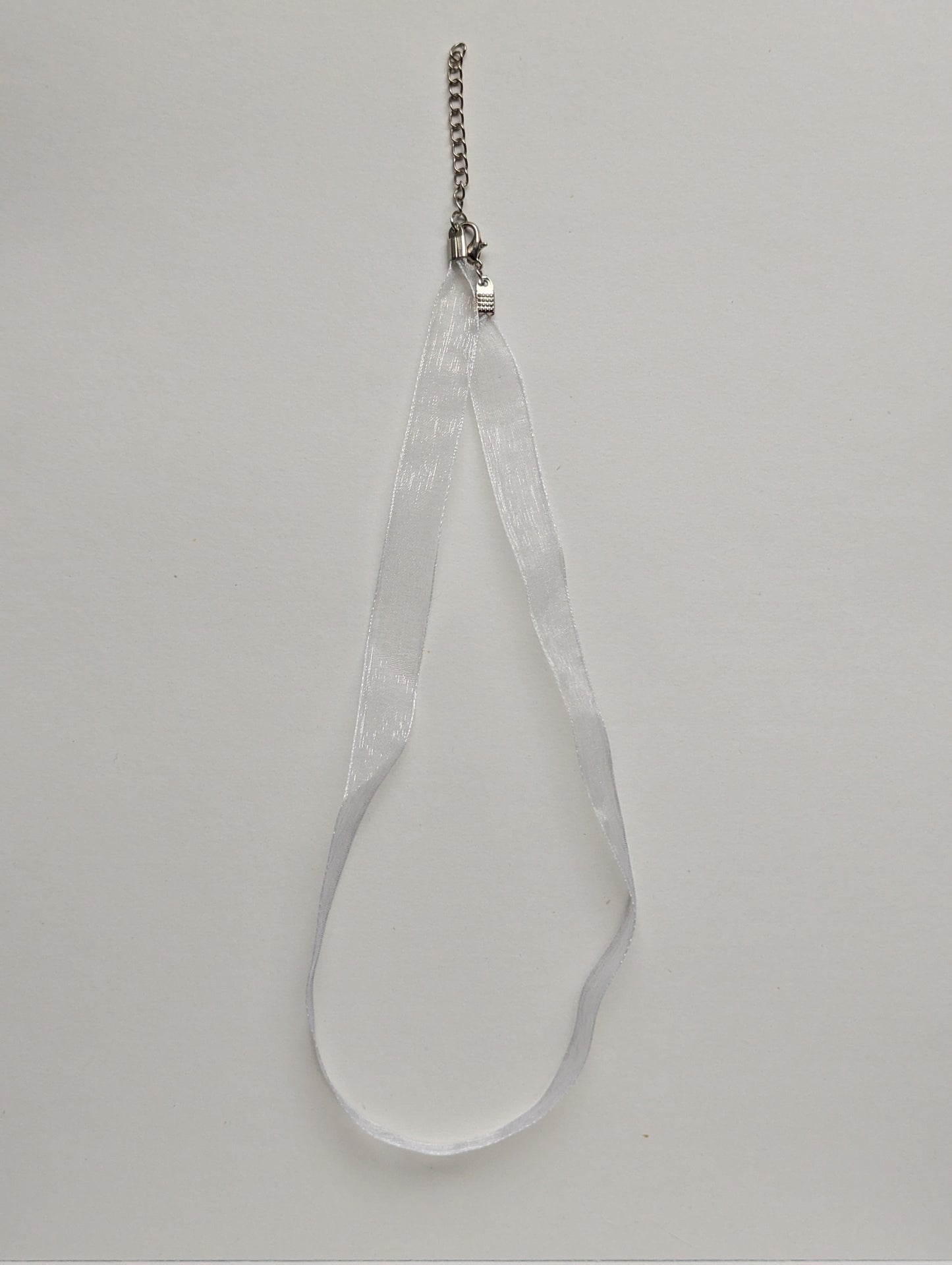 white ribbon necklace with silver metallic clasp and adjustable chain