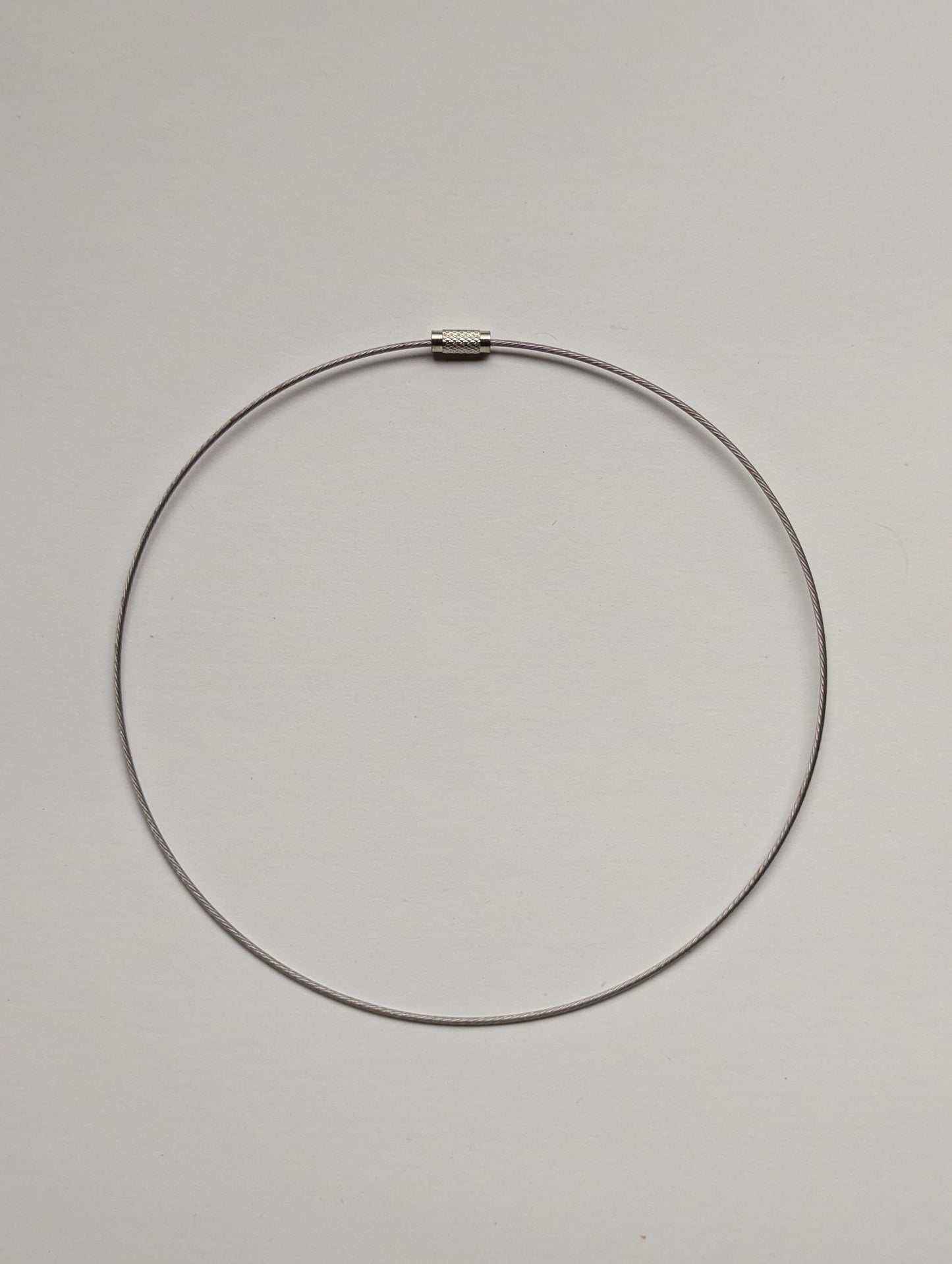 silver stainless steel necklace on a neutral background