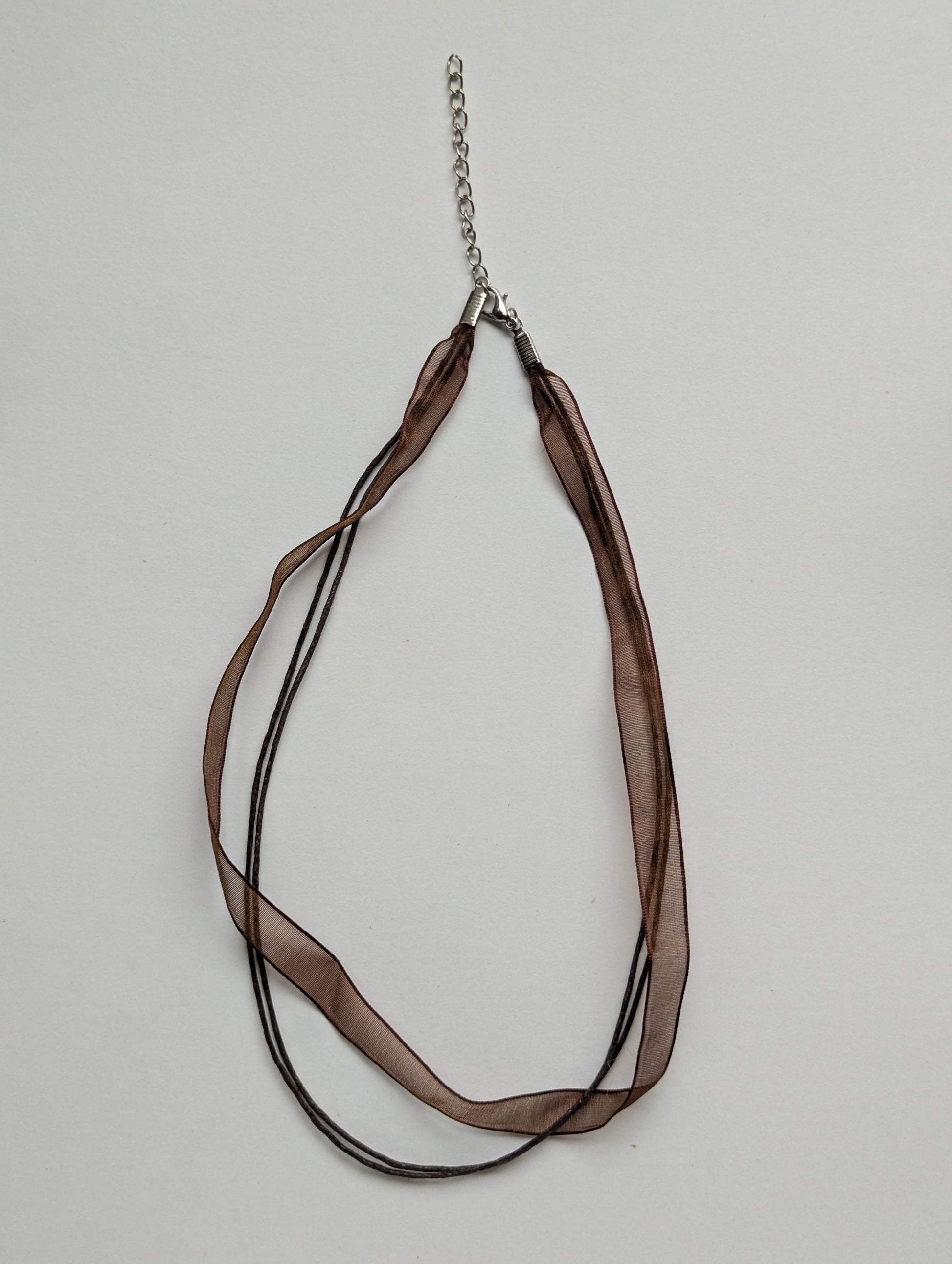 brown cotton cord organza ribbon necklace with silver metallic clasp and adjustable chain