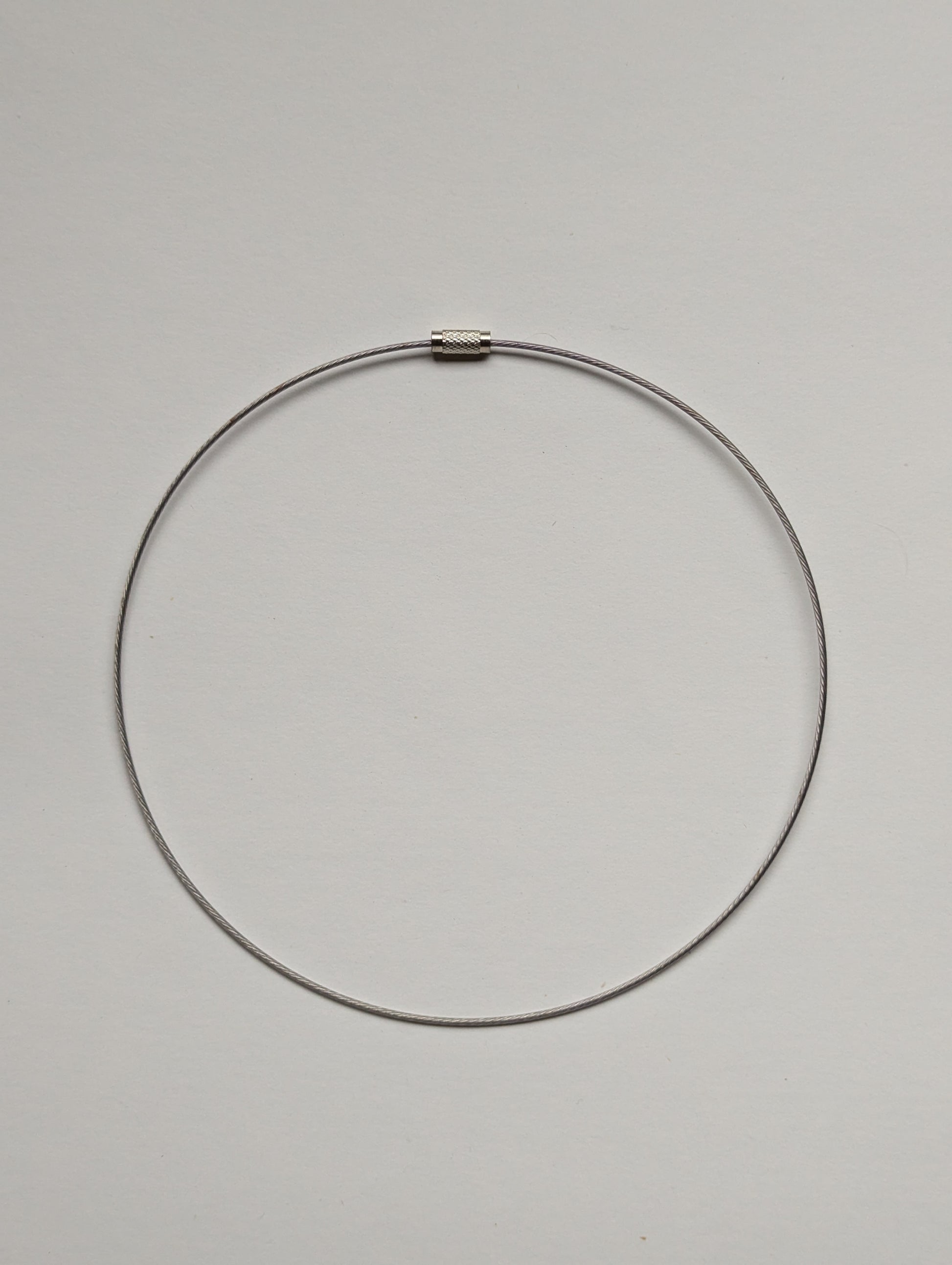 silver stainless steel necklace on a neutral background