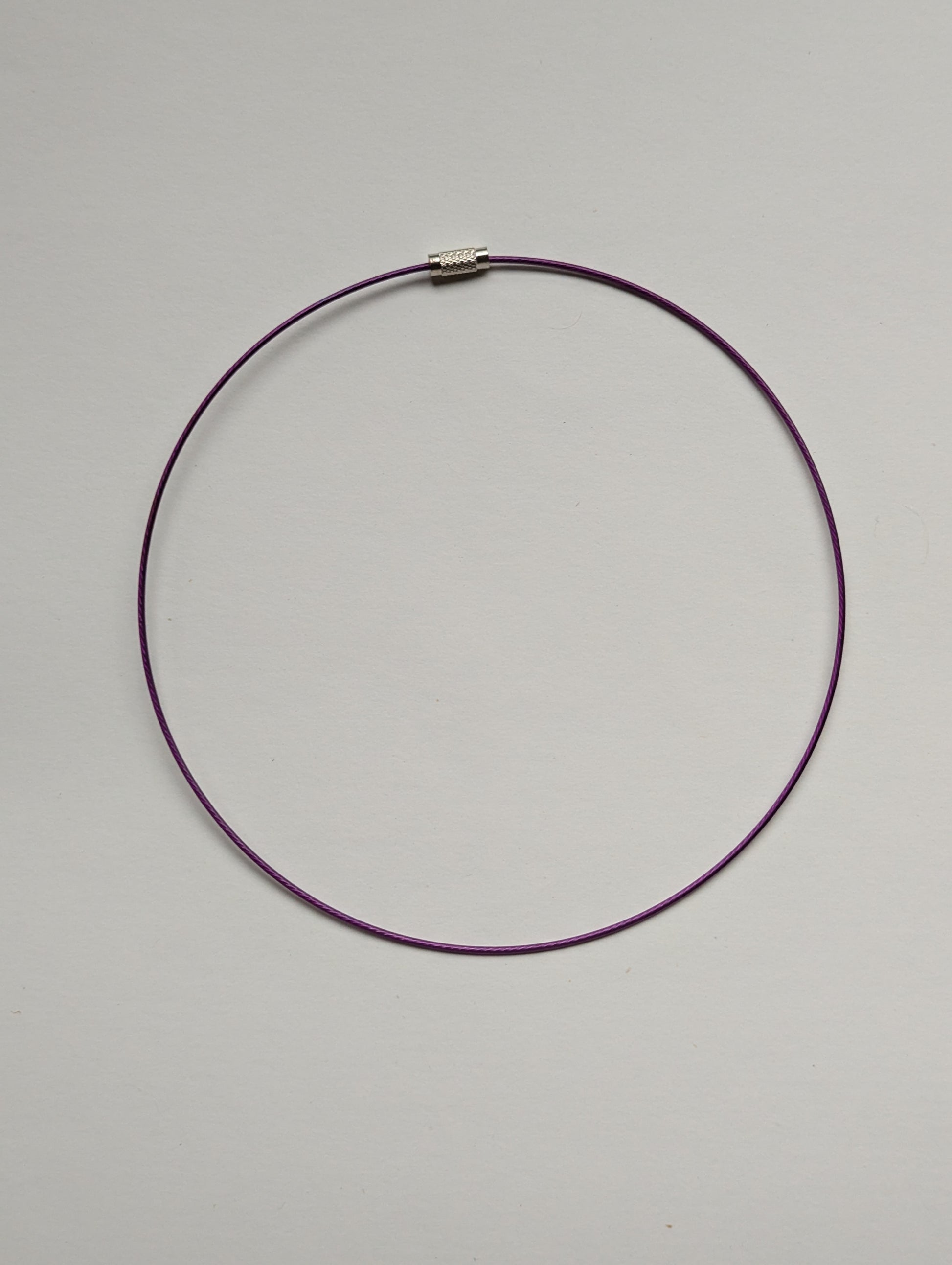 purple stainless steel necklace on a neutral background
